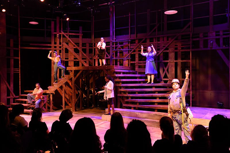 Group of theatre students performing on the Odess Theatre in front of an audience.