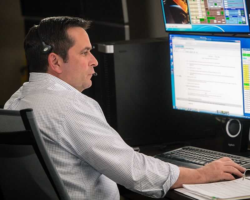 A man working at a desktop computer. 