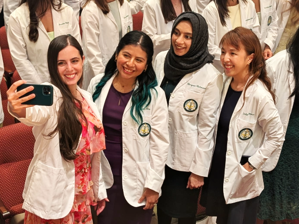D3 students posing together for a selfie group photo at 2025 White Coat Ceremony