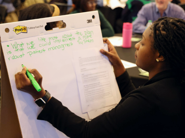 SOD staff member writing feedback on SOD strategic plan at fall EXCEL 2024 event