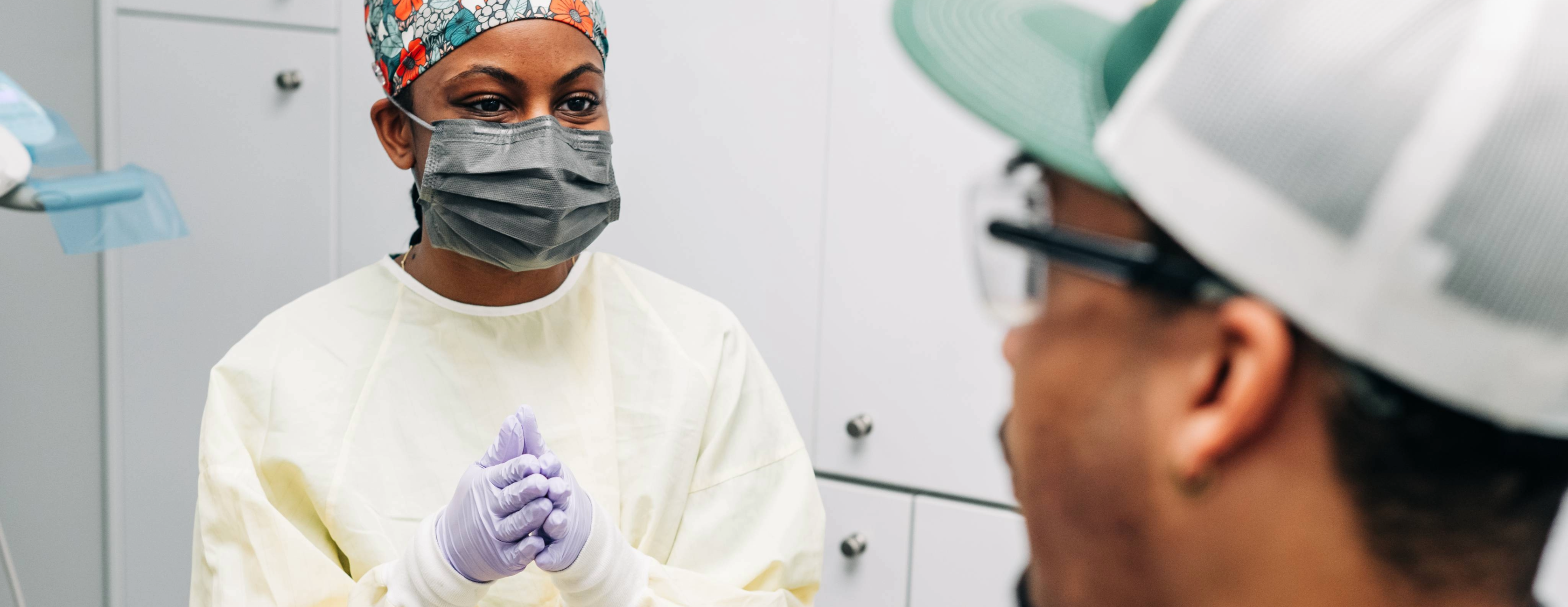 Student consulting with patient in clinic.