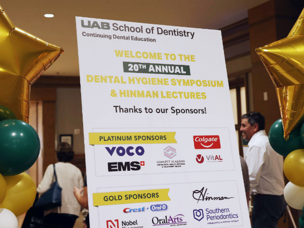 Hygiene Symposium sign with "20th Annual" highlighted and celebratory balloons on either side