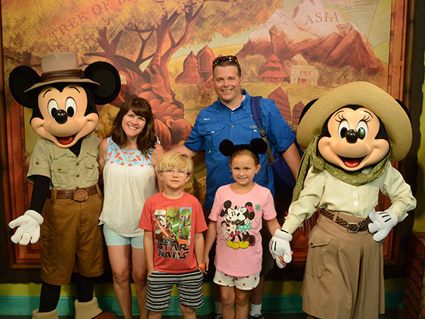 The Gillespie family poses with Micky and Minnie Mouse. 