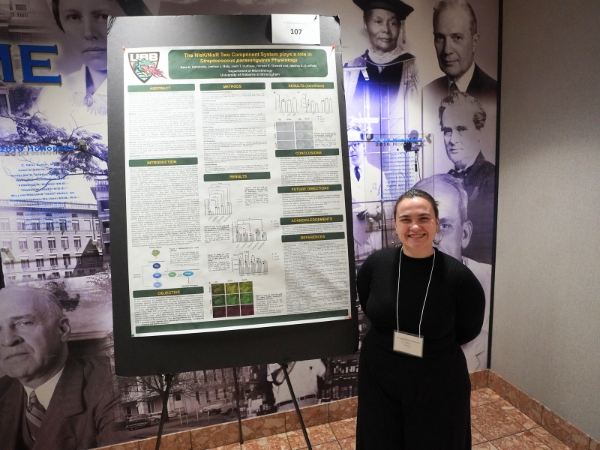 Sara Edmonds standing next to her poster that placed 2nd in the Pre Doctoral Basic Sciences category