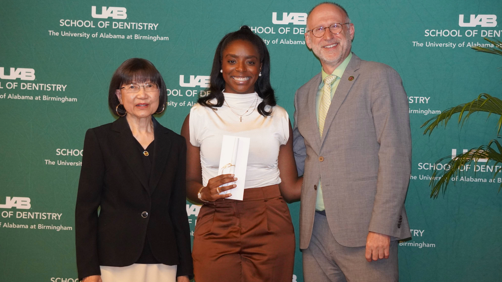 Dental student posing with Dean Geurs and dental leadership at Honors Convocation 2024