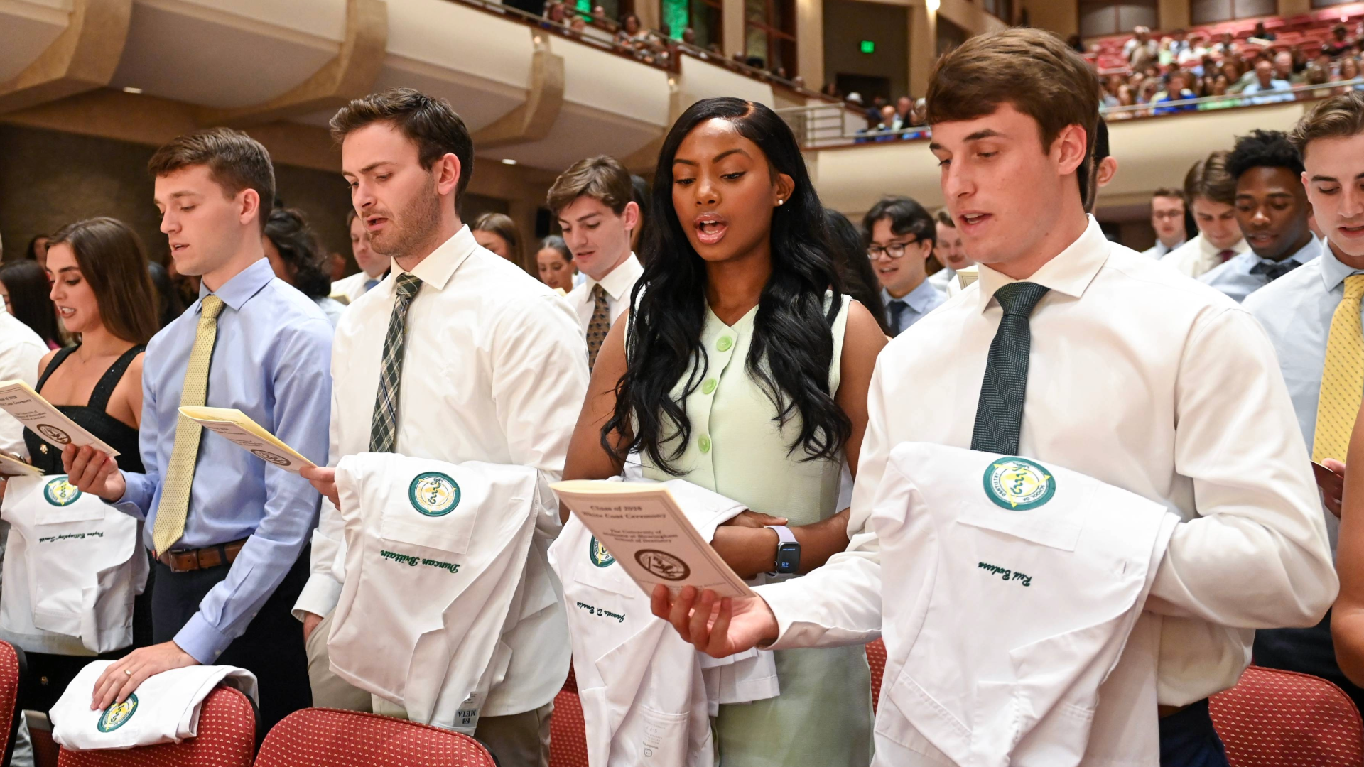 Group of dental students reciting dental pledge at 2024 White Coat Ceremony