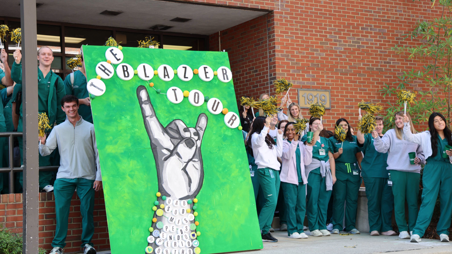 Group photo of UAB SOD Dental Students next to Blazer Build Decoration at Cudworth Building in 2024