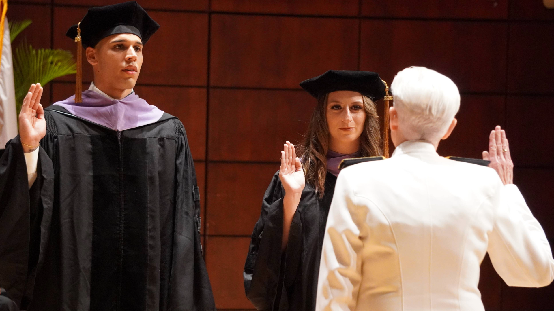 Students reciting oath at military commissioning at UAB SOD 2024 DMD Commencement