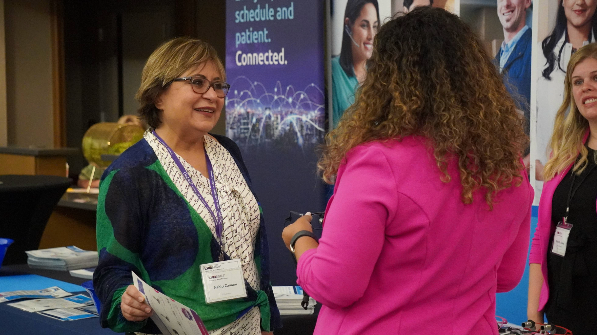 UAB SOD staff member speaking to vendor at Detnal Hygiene Sympoisum and Hinman Lectures 2024