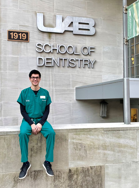 Jacob Martin sitting outside the School of Dentistry.