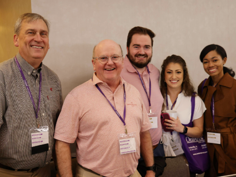 Alumni and students posing for a photo at an alumni weekend event.