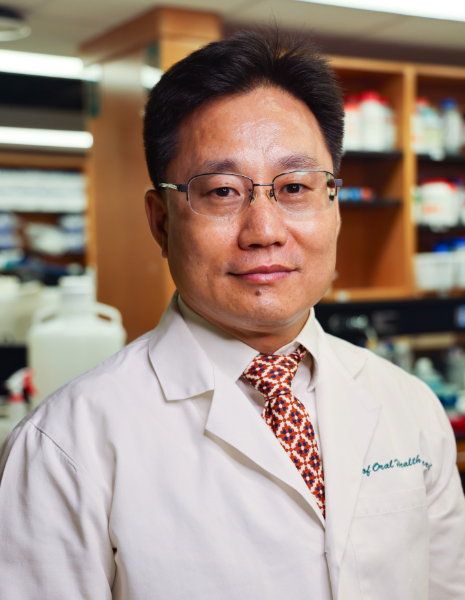 Man in white coat in lab setting