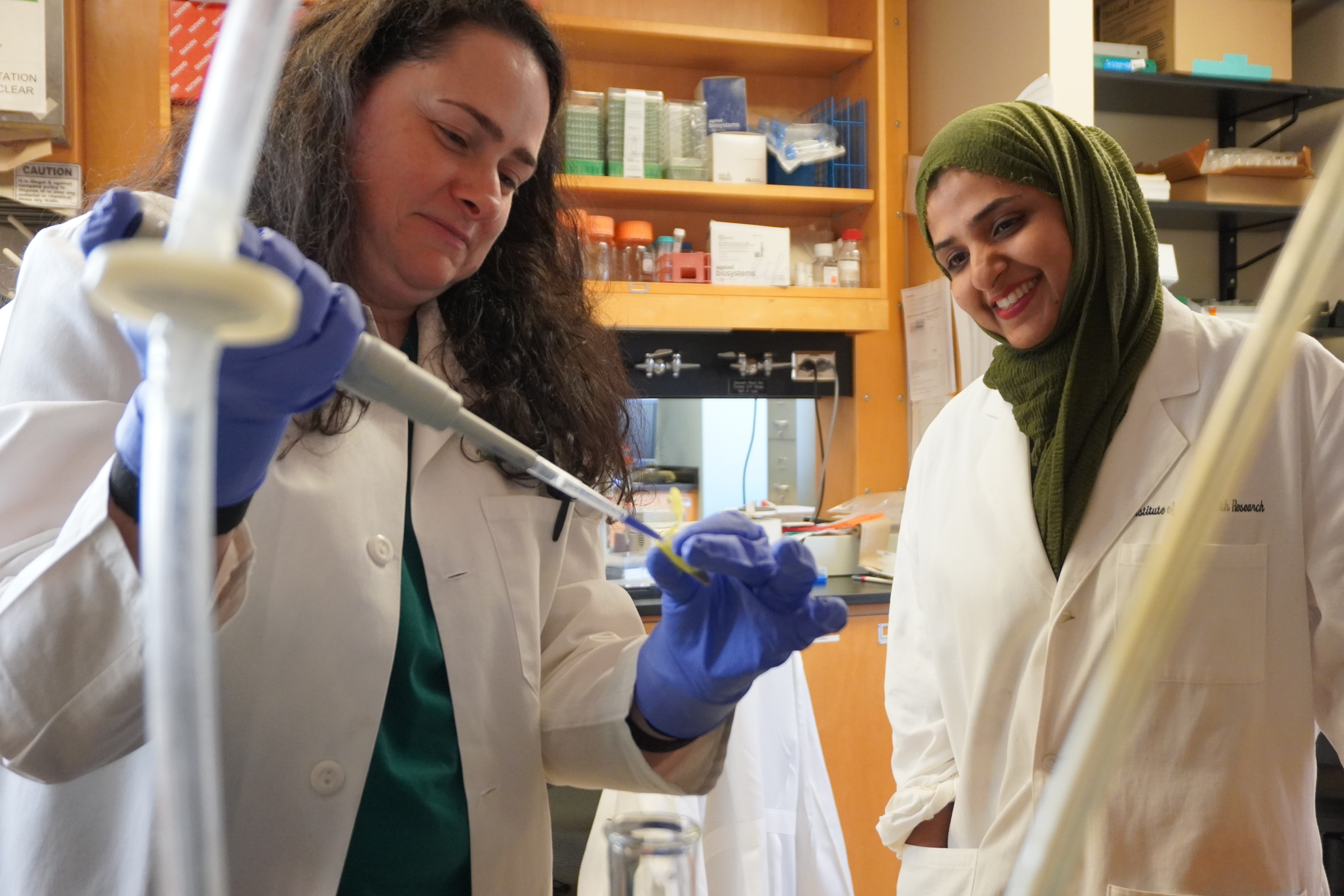 Dr. Amm working with student in lab