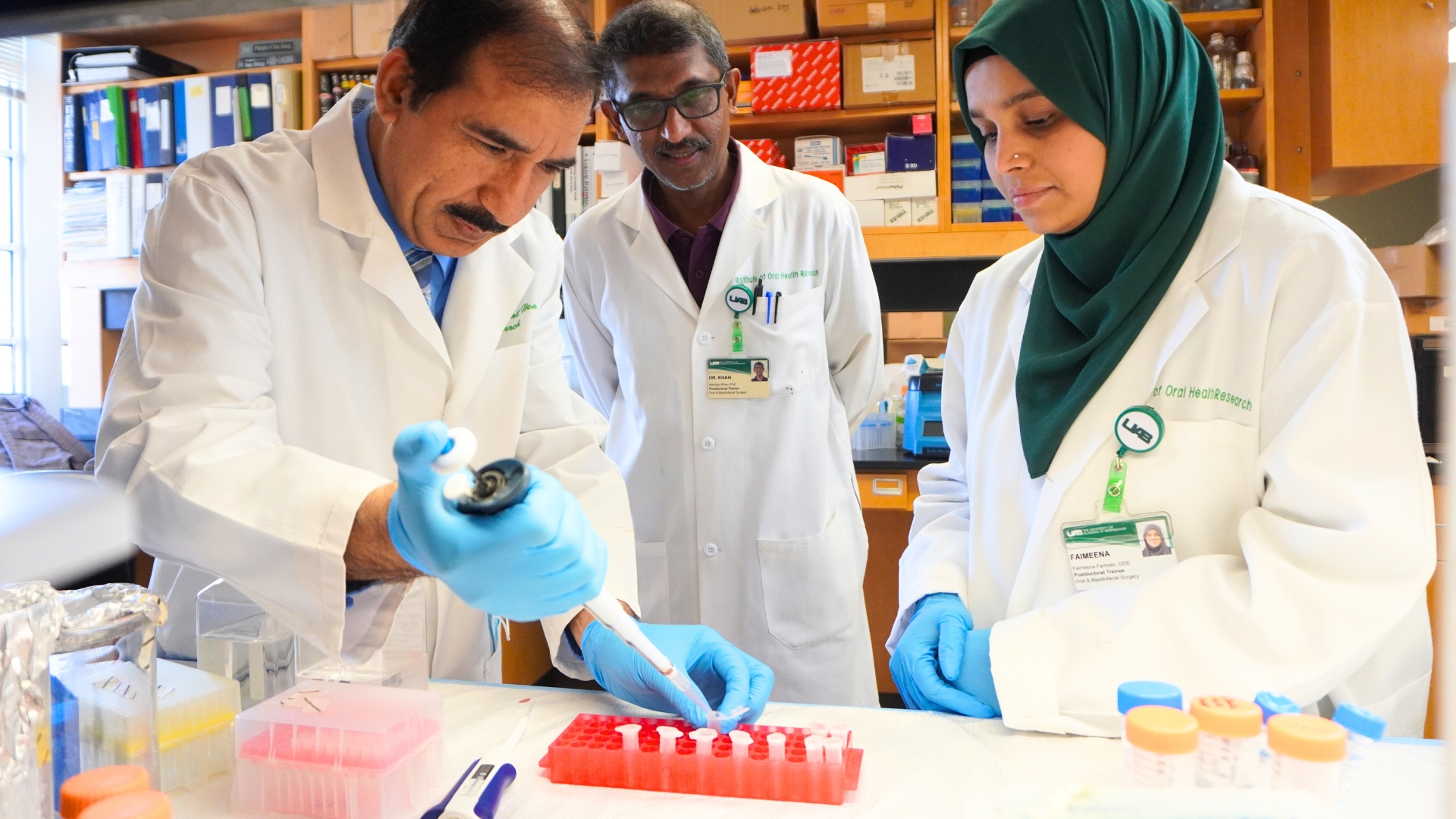 Dr. Javed working with students in lab