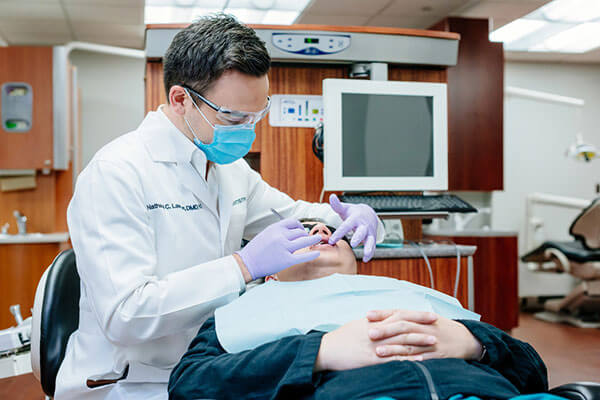 Dentist examining patient's mouth. 