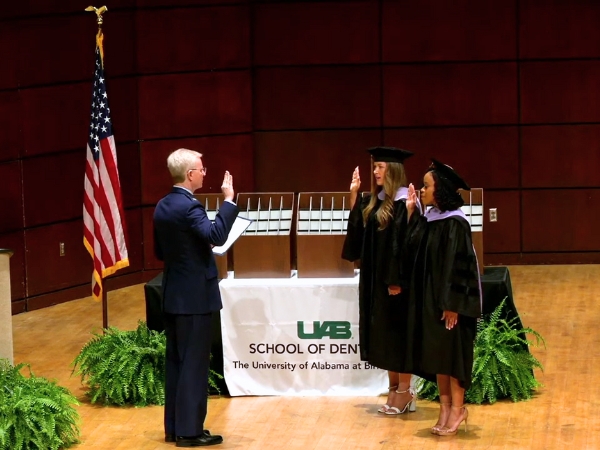 Angelina Rizzuto and Mallory Kent taking the U.S. Military Oath of Office led by Colonel Brent McClenny U.S. Air Force retired
