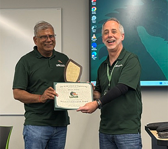Brian Pillay presented a certificate and plaque by Dean Jeff Holmes