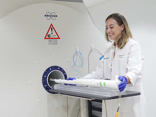Anna Sorace in front of imaging machine