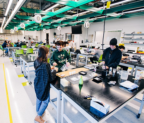 UAB undergraduate students collaborating in a large laboratory
