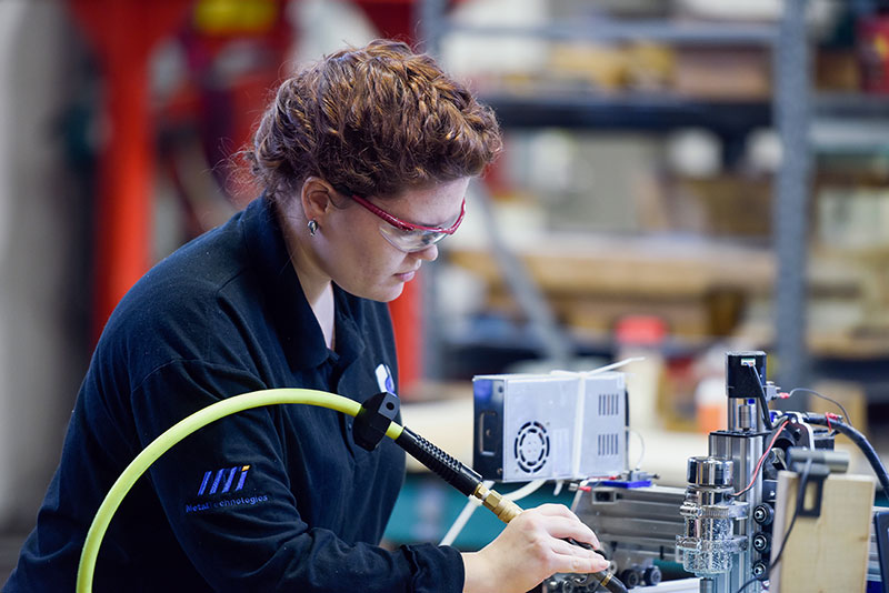 A female student workin in the Materials Processing and Applications Development Center.