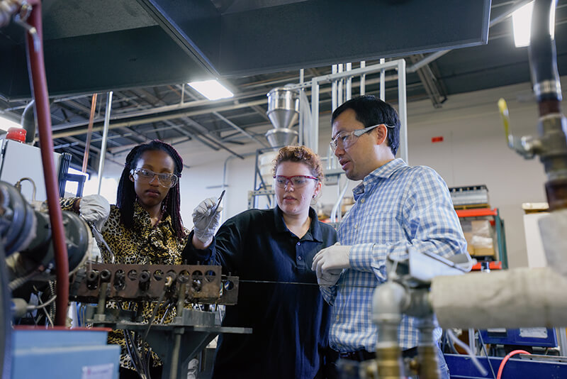 A faculty member and students in the MPAD facility. 