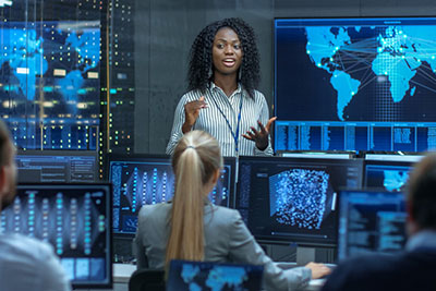 Woman giving presentation in high tech computer lab.