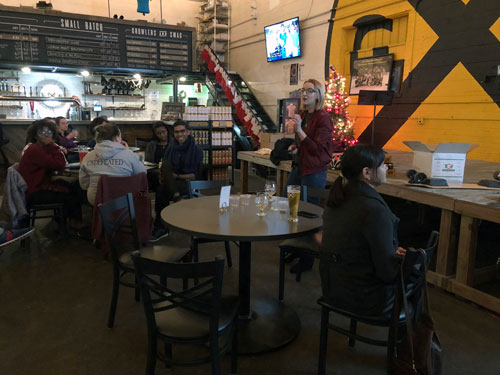 Jessica Kepple lecturing at Ghost Train in front of crowd.