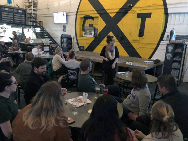 Sarah Adkins speaking to an audience at Ghost Train Brewing.