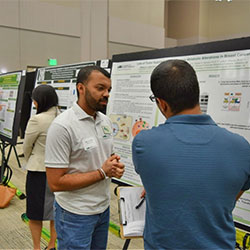 Two students looking at research poster.