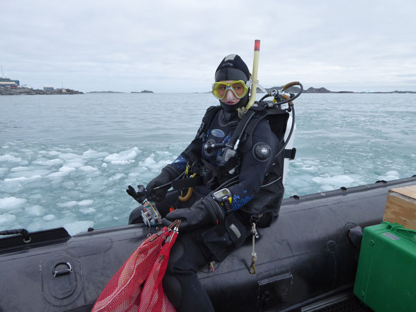 Sabriana Heiser on a boat wearing scuba gear.