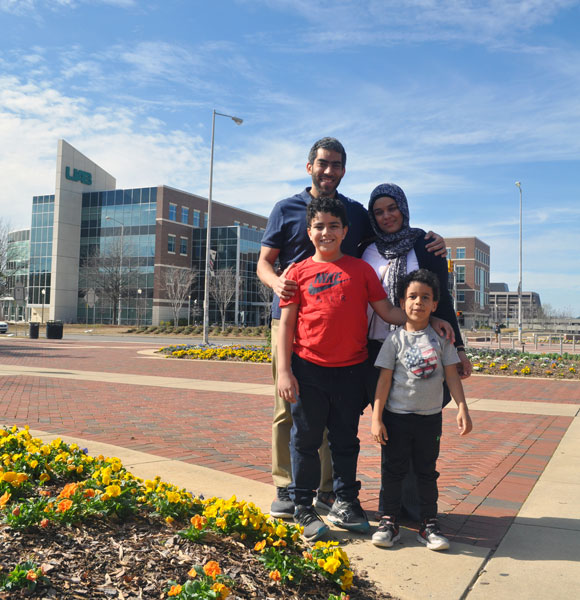Hisham Abdelmotilib posing with his family.