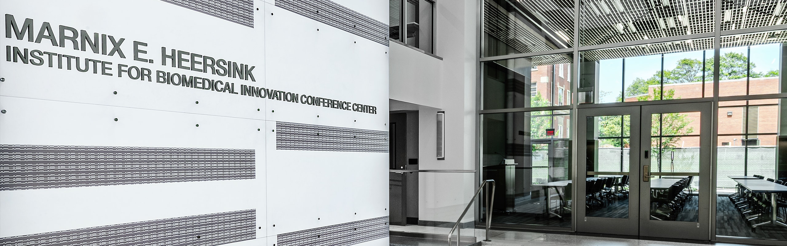 Lobby of the conference center, a long white, black, and stainless steel interior.