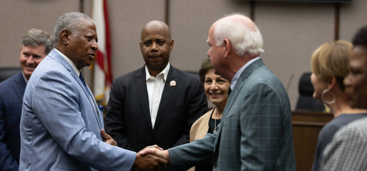 UAB President Watts shaking hands with individuals at a Selma event.