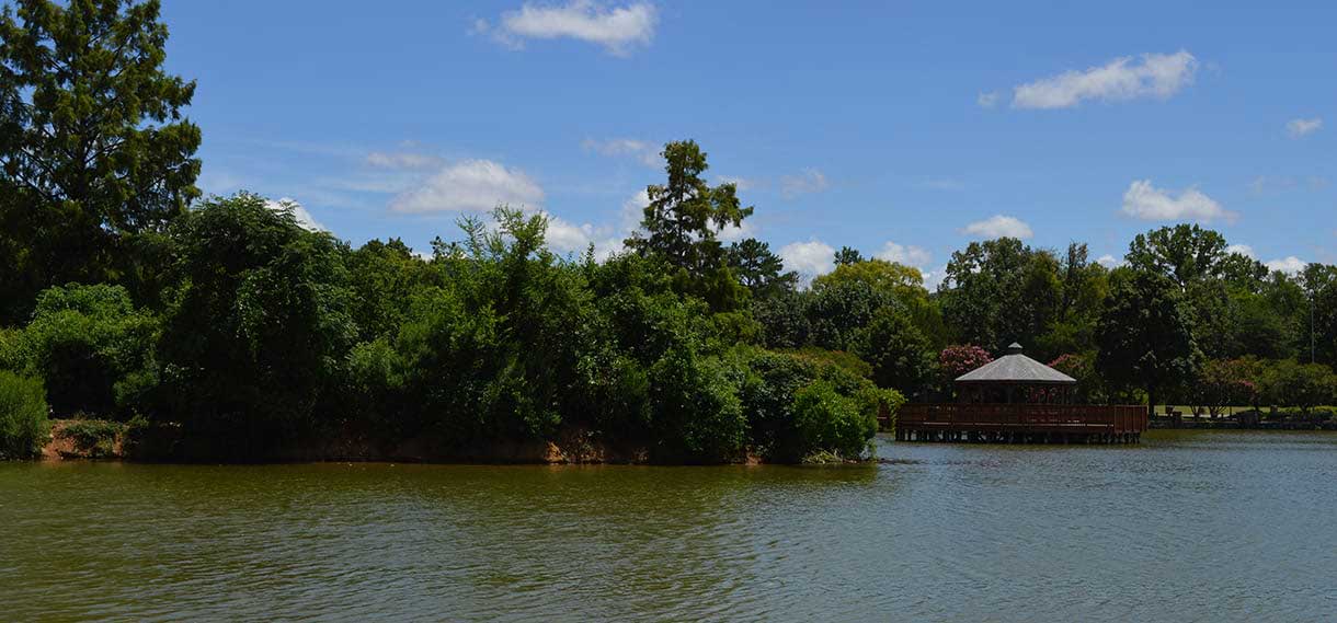 The lake, featuring trees and a gazebo.