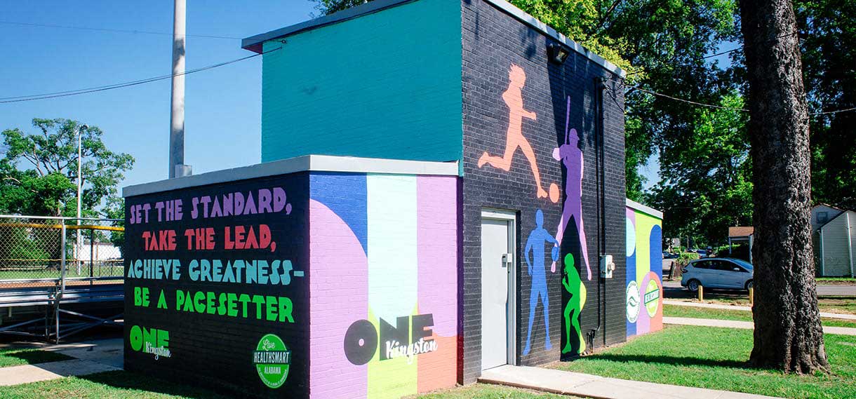 Another view of the Kingston concession stand and its murals, featuring people playing sports.