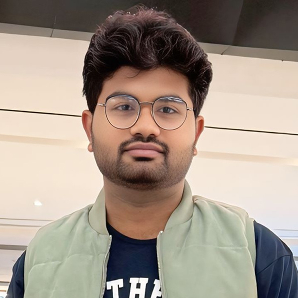 Headshot of Biru Dudhabhate, Ph.D., wearing glasses, a light-colored vest, and a dark shirt