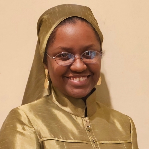 Headshot of Maria Jones-Muhammad, Ph.D., wearing glasses and a gold-colored outfit