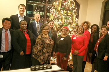 Faculty and staff from the Division of Preventive Medicine around the tree.