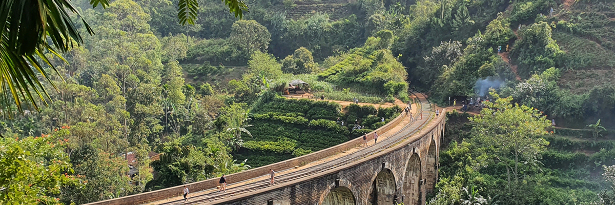 Image of the iconic old railway bridge in the tropical jungle near Ella, Sri Lanka