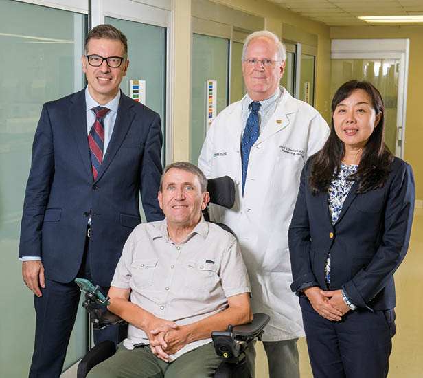 UAB ALS Clinic  co-directors Mohamed Kazamel, M.D., and Nan Jiang, M.D. (at left and right), Department of Neurology Chair David Standaert, M.D., Ph.D. (center back), and clinic patient and ALS advocate Kelly Butler (at front).