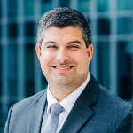 Professional man wearing a white doctor's coat and suit