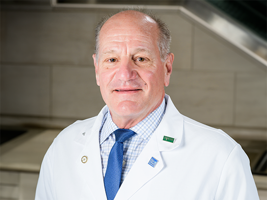 Dr. Mark Hadley's white coat headshot