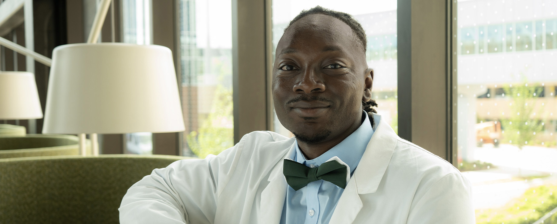 Photo of Leopold Nkengbeza in white coat, smiling. He is a fourth-year medical student at UAB Heersink School of Medicine.