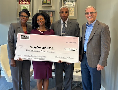Desalyn Johnson being presented with a $4,000 scholarship check