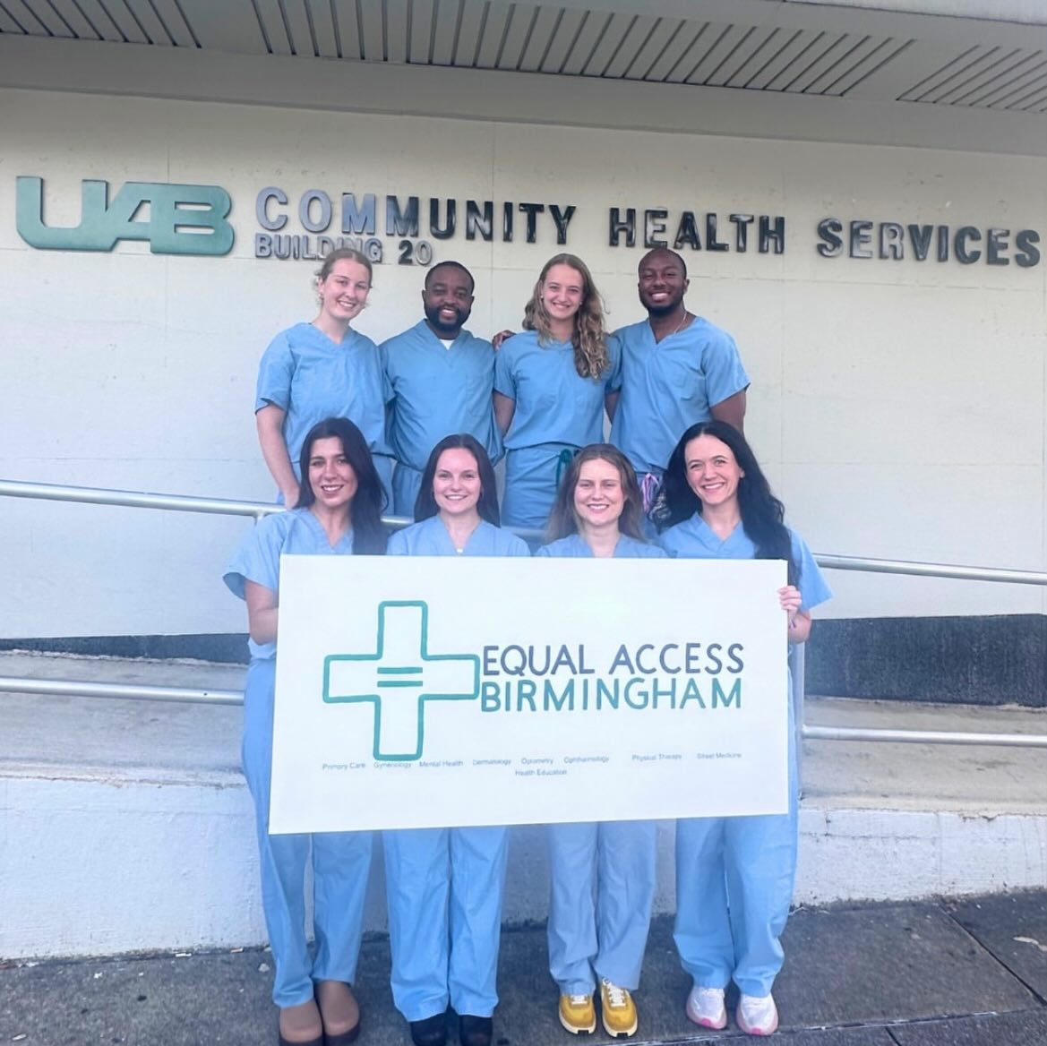 Group of medical students holding an Equal Access Birmingham sign