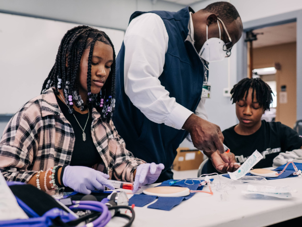 Person with students and medical supplies
