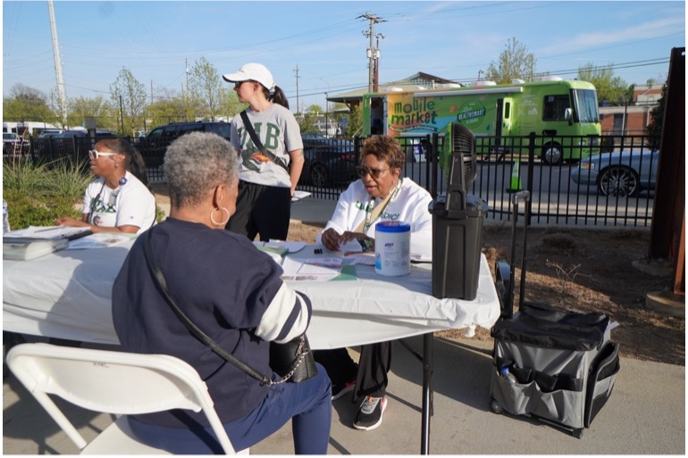 Community health coach writing a prescription for community health for a community member