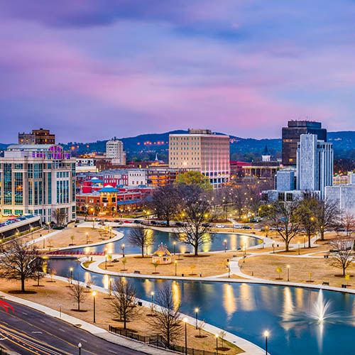 Huntsville, Alabama, USA park and downtown cityscape at twilight.