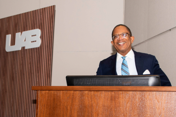 Dr. Selwyn Vickers standing at podium