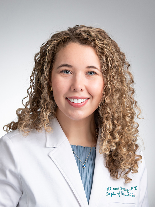 Headshot of Dr. Alinea Esensoy, MD, Assistant Professor in Neurology, in white medical coat.